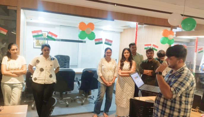 Team members celebrating Independence Day with tricolour flags