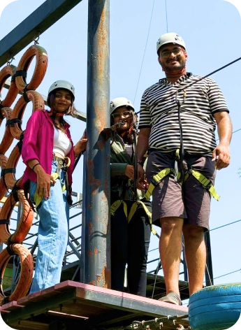 Team members enjoying a high ropes challenge at an adventure resort