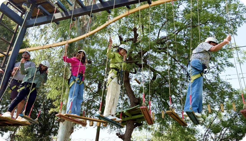 Colleagues participating in a thrilling rope course during company trip