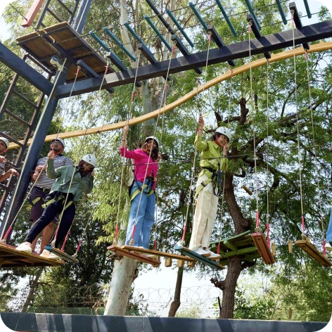 Colleagues participating in a thrilling rope course during company trip