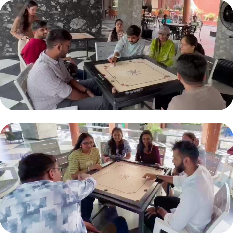Team members enjoying a friendly game of carrom during the trip